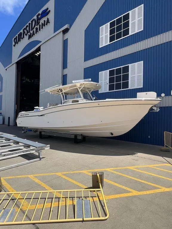 The Image of 2012 Grady-White 336 Canyon boat outside Surfside Marina, blue and white building in background. - 1