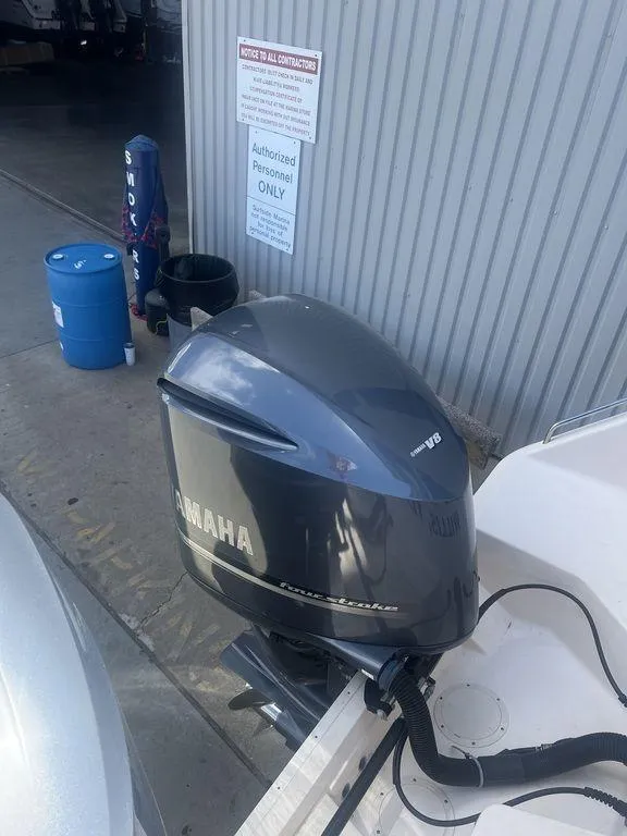 Slide: The Image of 2012 Grady-White 336 Canyon with Yamaha outboard motor in a marina setting. - 11