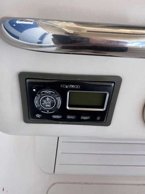 Slide: The Image of Kenwood stereo system on 2012 Grady-White 336 Canyon boat dashboard. - 18