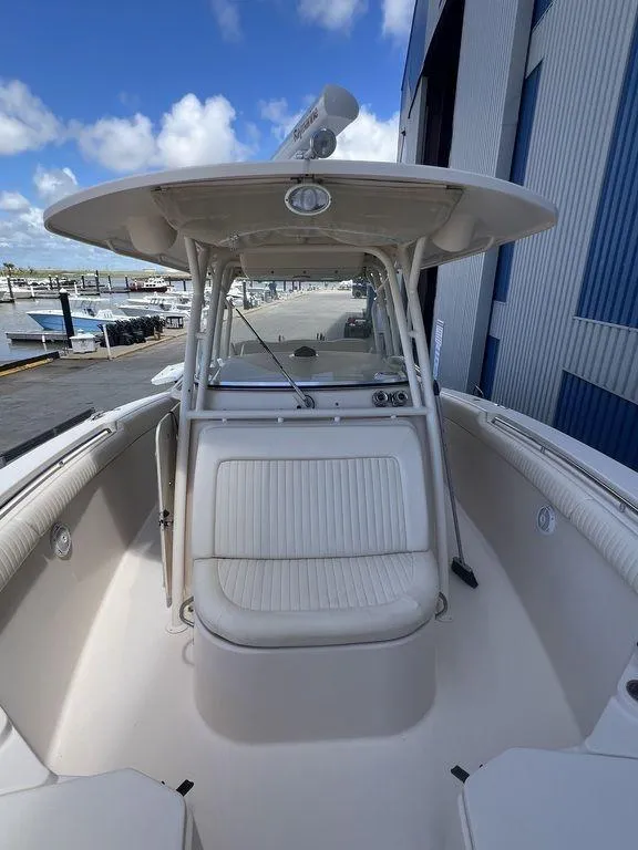 Slide: The Image of 2012 Grady-White 336 Canyon boat, spacious deck, marina background, clear sky. - 24