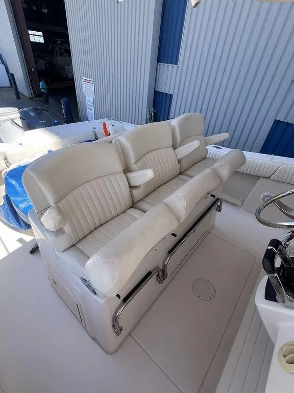 Slide: The Image of 2012 Grady-White 336 Canyon boat interior with white cushioned seating. - 27