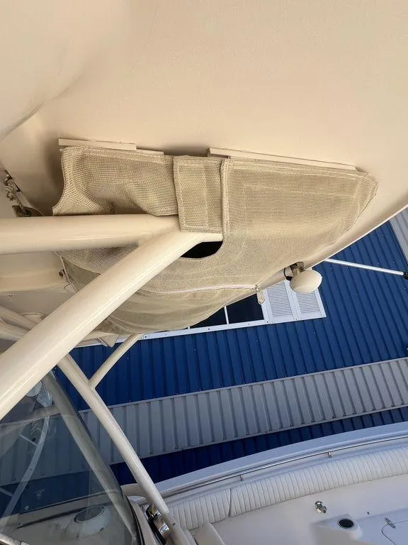 Slide: The Image of 2012 Grady-White 336 Canyon boat detail, featuring structural elements and canvas cover. - 30