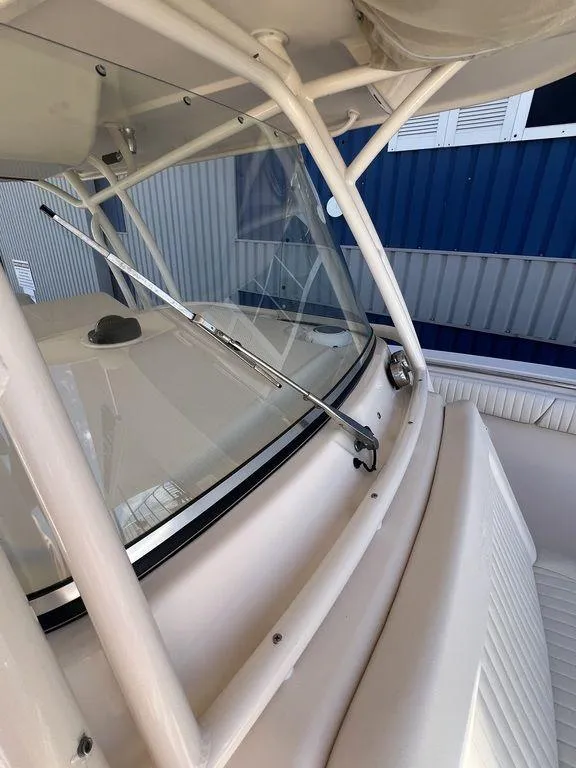 Slide: The Image of 2012 Grady-White 336 Canyon boat windshield and seating area. - 32