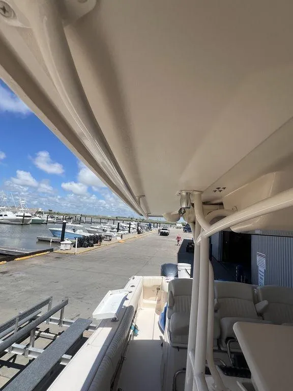 Slide: The Image of 2012 Grady-White 336 Canyon boat docked at marina under clear blue sky. - 33