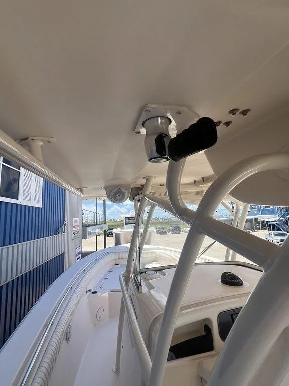 Slide: The Image of 2012 Grady-White 336 Canyon boat interior, featuring helm and seating area. - 35