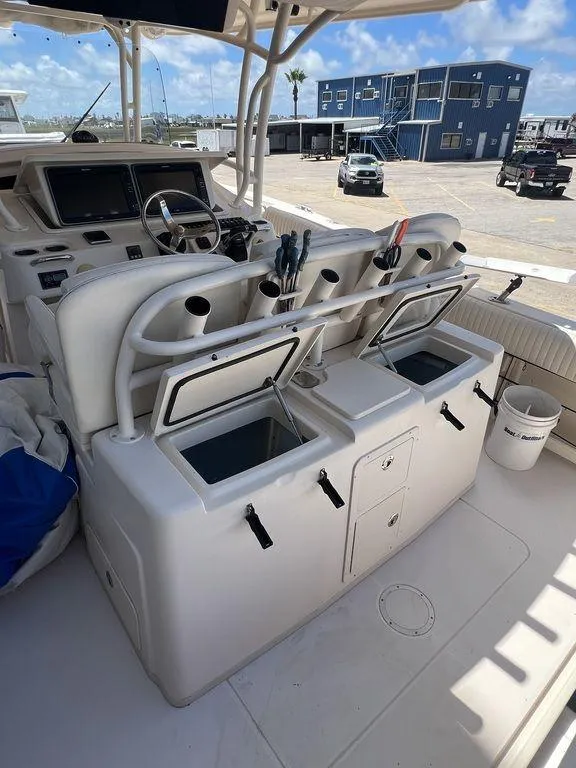 Slide: The Image of 2012 Grady-White 336 Canyon boat interior with fishing rod holders and storage compartments. - 37