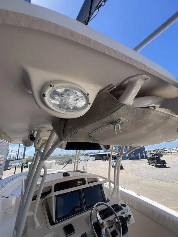 Slide: The Image of 2012 Grady-White 336 Canyon boat interior, featuring helm and overhead storage. - 38