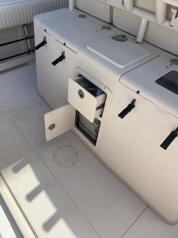 Slide: The Image of 2012 Grady-White 336 Canyon boat interior with storage compartments open. - 39