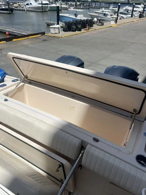 Slide: The Image of 2012 Grady-White 336 Canyon boat with open storage compartment at marina. - 41