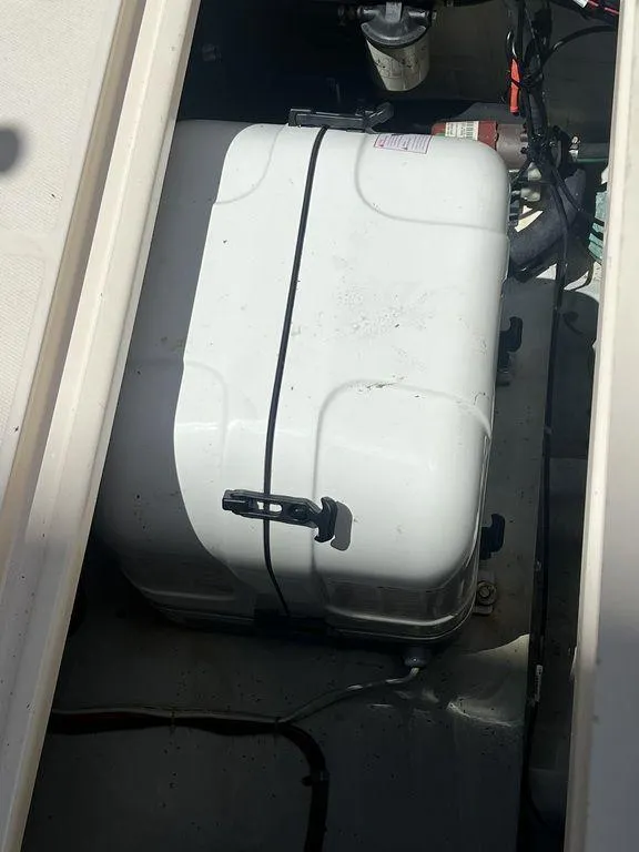 Slide: The Image of 2012 Grady-White 336 Canyon boat compartment with secured white storage box. - 43