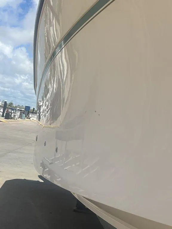 Slide: The Image of 2012 Grady-White 336 Canyon boat hull in a marina setting. - 6