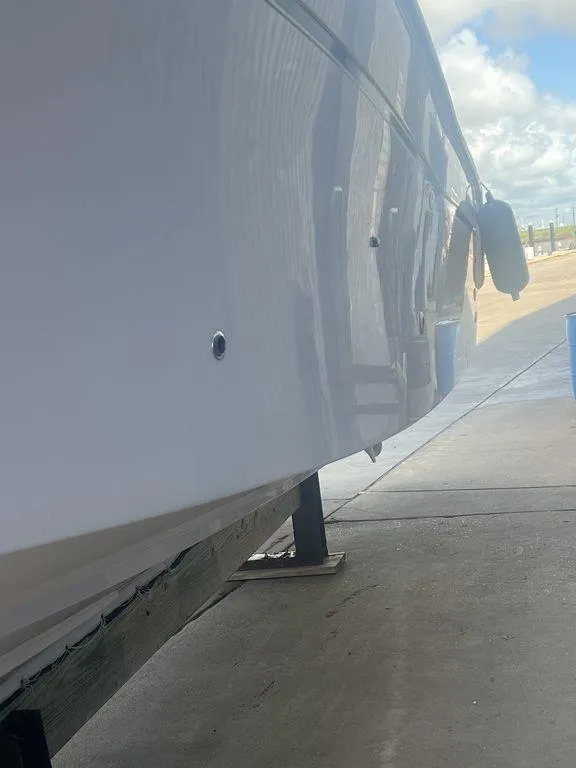 Slide: The Image of 2012 Grady-White 336 Canyon boat hull on a stand, side view. - 7