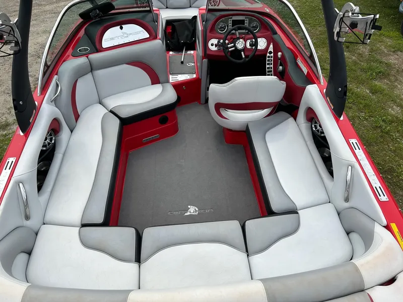 Slide: The Image of 2012 Centurion Enzo SV211 boat interior with red and gray seating. - 3