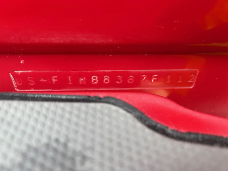 Slide: The Image of Close-up of a 2012 Centurion Enzo SV211 hull identification number on red surface. - 8