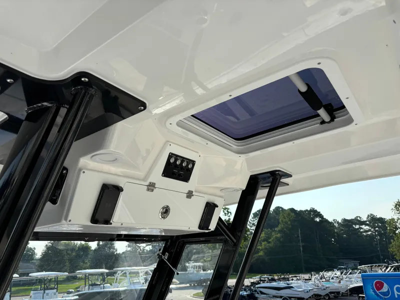 Slide: The Image of Interior view of 2025 Sea Fox 328 Commander boat with sunroof and control panel. - 10