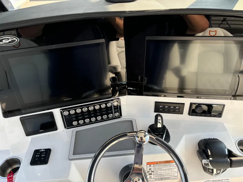 Slide: The Image of Helm of 2025 Sea Fox 328 Commander with dual displays and modern controls. - 11