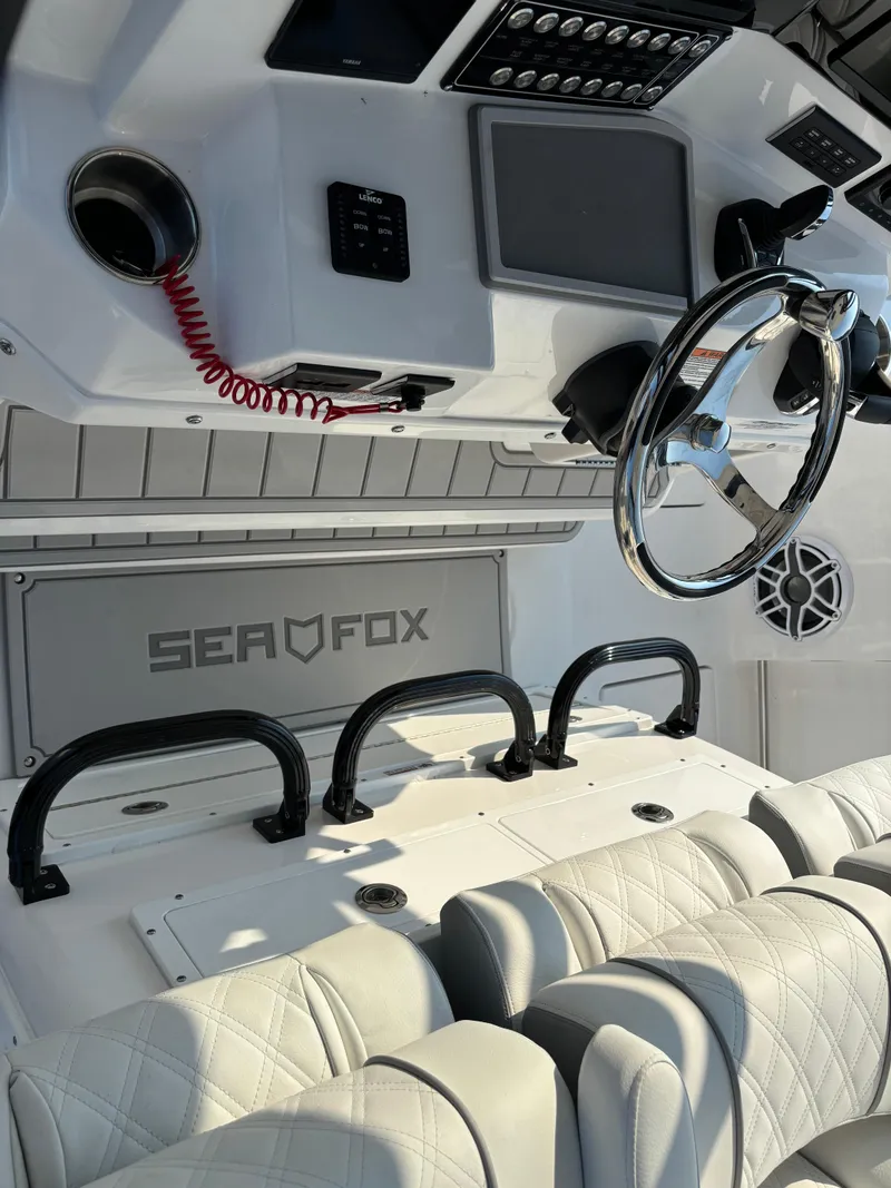 Slide: The Image of 2025 Sea Fox 328 Commander boat interior with steering wheel and seating. - 15