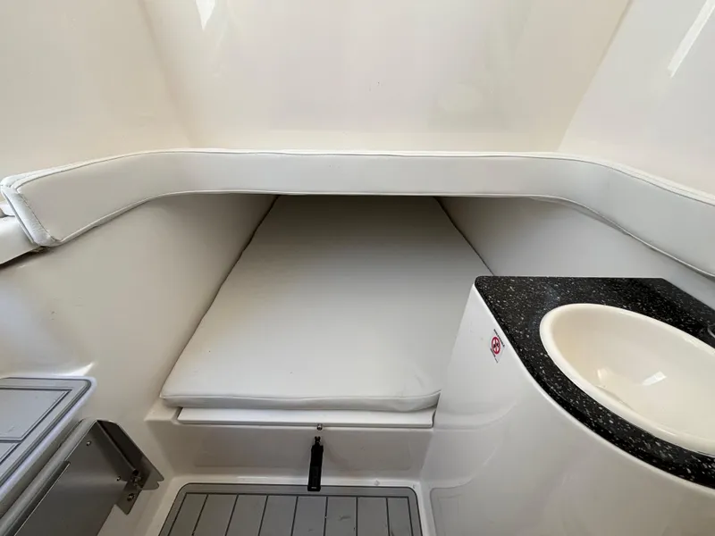 Slide: The Image of 2025 Sea Fox 328 Commander cabin interior with cushioned seating and sink. - 16