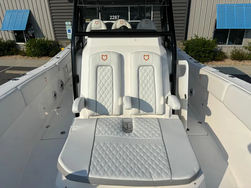 Slide: The Image of 2025 Sea Fox 328 Commander boat interior with white cushioned seating. - 19
