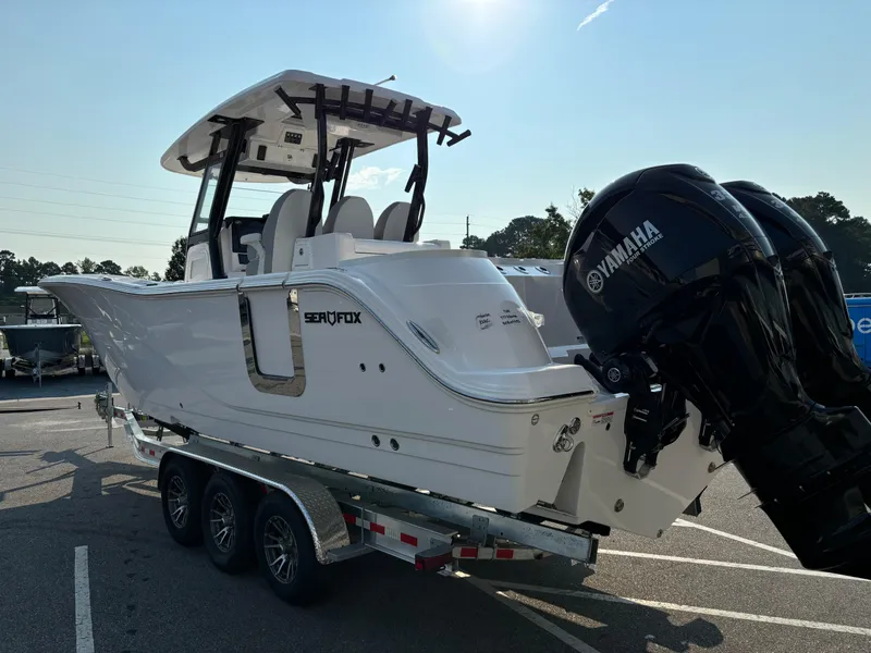Slide: The Image of 2025 Sea Fox 328 Commander boat on trailer with Yamaha engines, parked outdoors. - 28