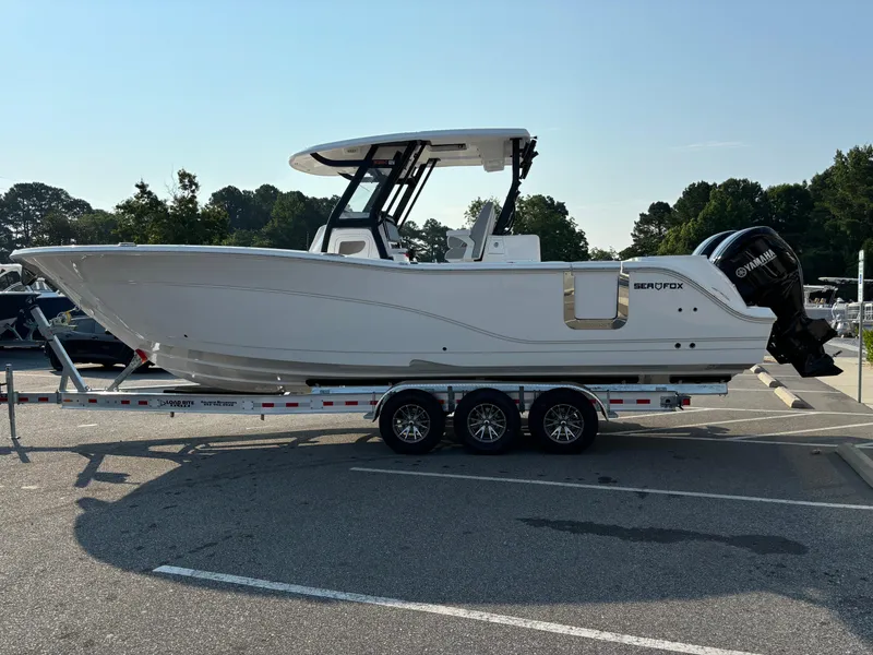 Slide: The Image of 2025 Sea Fox 328 Commander boat on trailer in parking lot. - 29