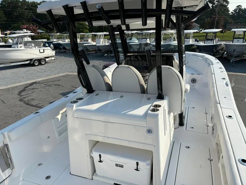 Slide: The Image of 2025 Sea Fox 328 Commander boat interior with seating and storage, docked in a marina. - 4