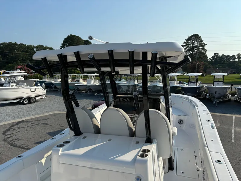 Slide: The Image of 2025 Sea Fox 328 Commander boat with T-top and seating, parked in a marina. - 5