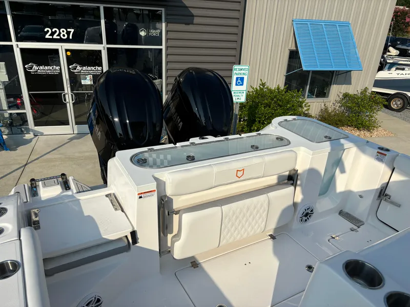 Slide: The Image of 2025 Sea Fox 328 Commander boat with dual engines, docked near a building. - 6