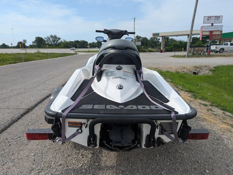 Slide: The Image of 2006 Sea-Doo GTX jet ski on a trailer, parked on a roadside. - 5