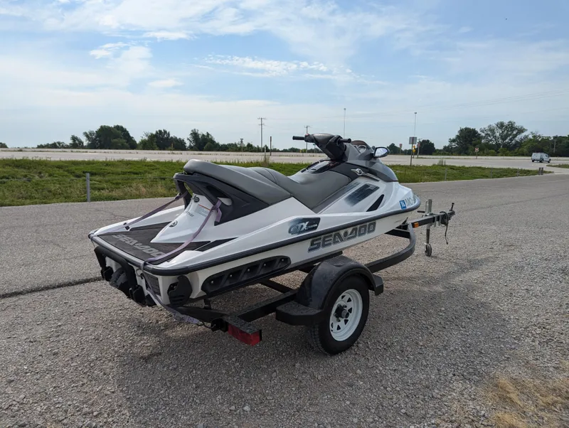 Slide: The Image of 2006 Sea-Doo GTX jet ski on trailer, parked on roadside. - 7