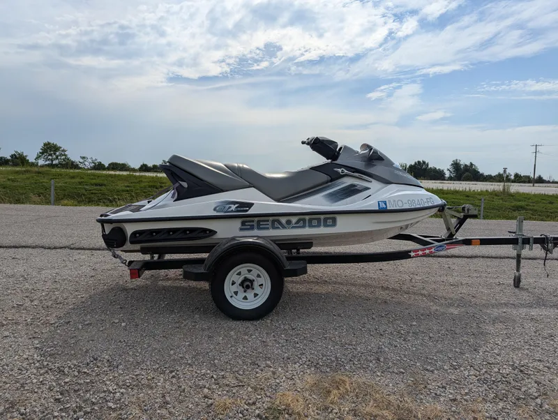 Slide: The Image of 2006 Sea-Doo GTX jet ski on trailer, parked on gravel road. - 8