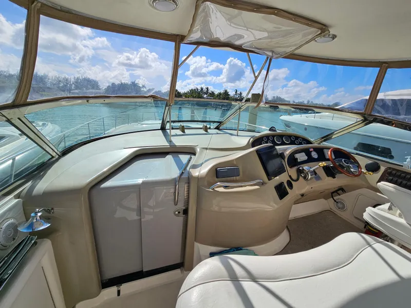 Slide: The Image of 2002 Sea Ray 460 Sundancer helm with panoramic views and modern controls. - 10