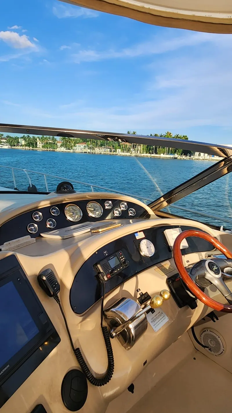 Slide: The Image of 2002 Sea Ray 460 Sundancer helm with scenic water view. - 12