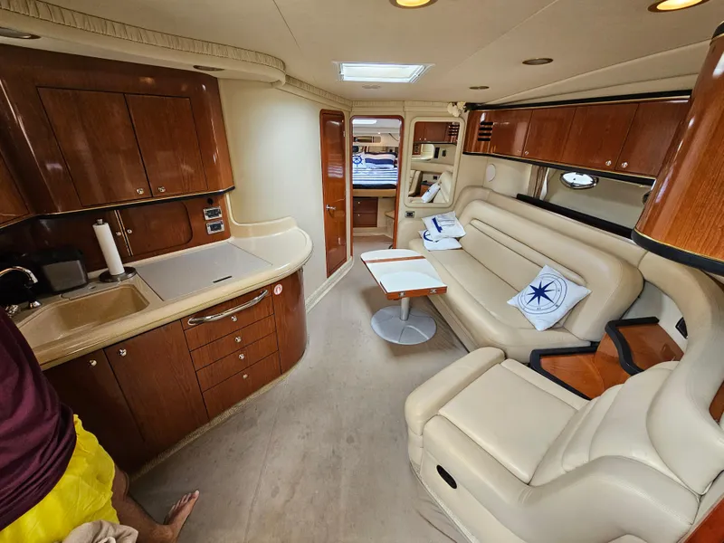 Slide: The Image of Interior of 2002 Sea Ray 460 Sundancer yacht with elegant wood cabinetry and plush seating. - 21