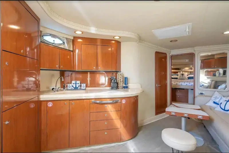 Slide: The Image of Luxurious interior of 2002 Sea Ray 460 Sundancer yacht with wood cabinetry and seating area. - 22