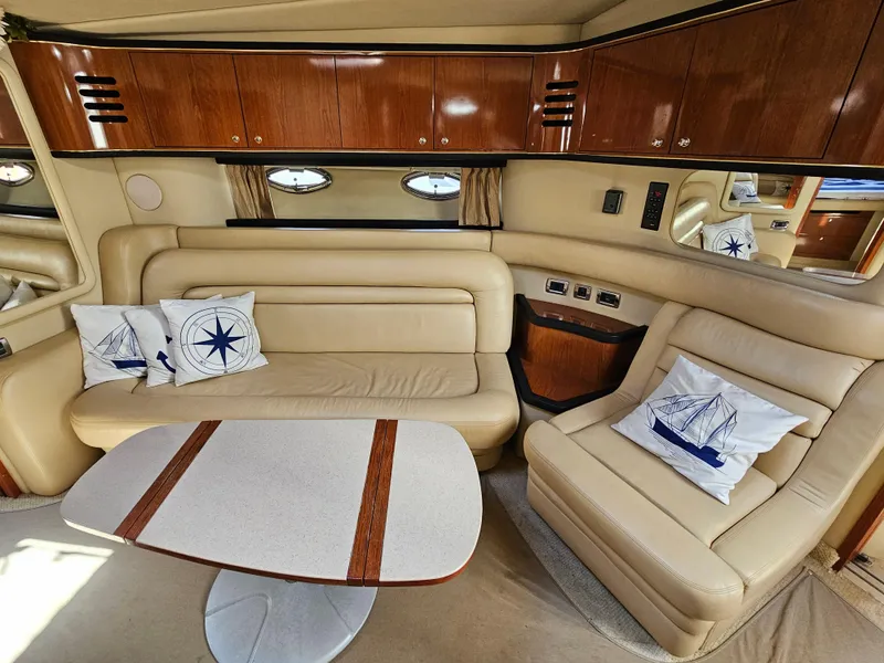 Slide: The Image of Luxurious interior of a 2002 Sea Ray 460 Sundancer yacht with beige leather seating. - 24
