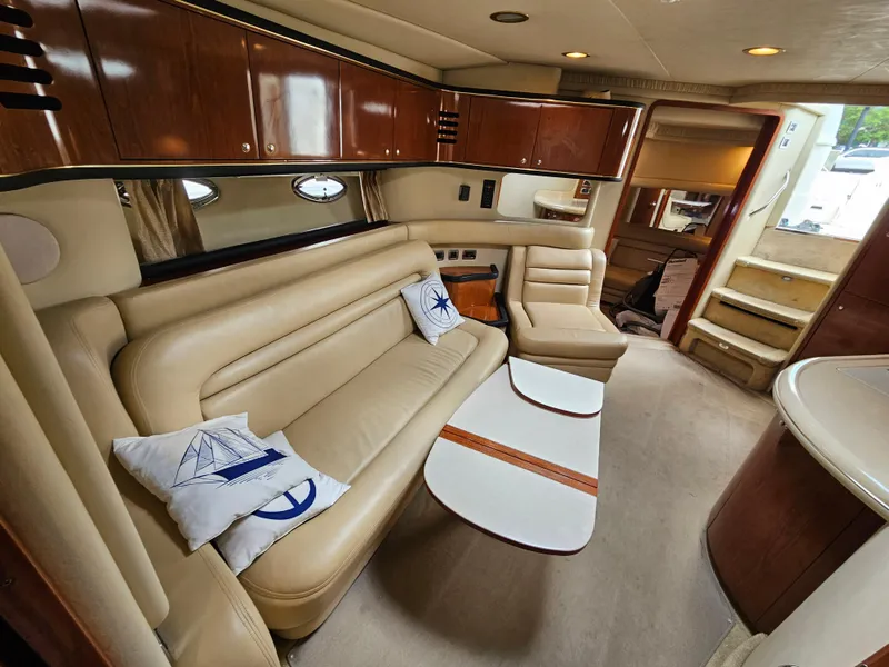 Slide: The Image of Luxurious 2002 Sea Ray 460 Sundancer yacht interior with beige leather seating and nautical decor. - 25