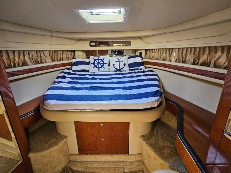 Slide: The Image of 2002 Sea Ray 460 Sundancer cabin with nautical-themed bedding. - 26