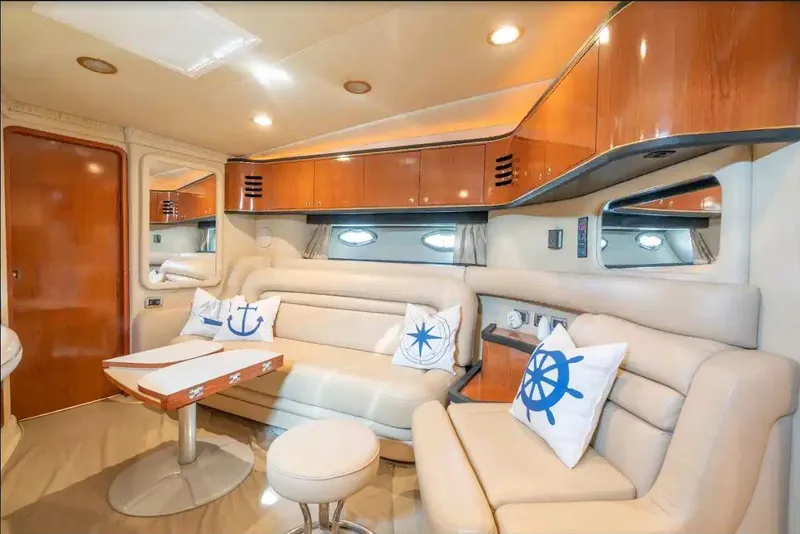 Slide: The Image of Luxurious interior of 2002 Sea Ray 460 Sundancer yacht with plush seating and nautical decor. - 27