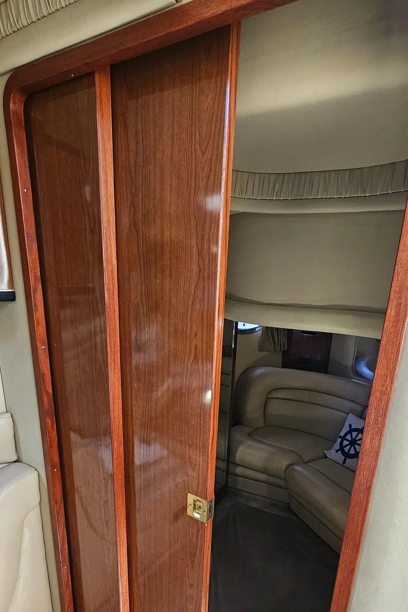 Slide: The Image of Interior cabin of a 2002 Sea Ray 460 Sundancer yacht with wooden sliding door. - 28