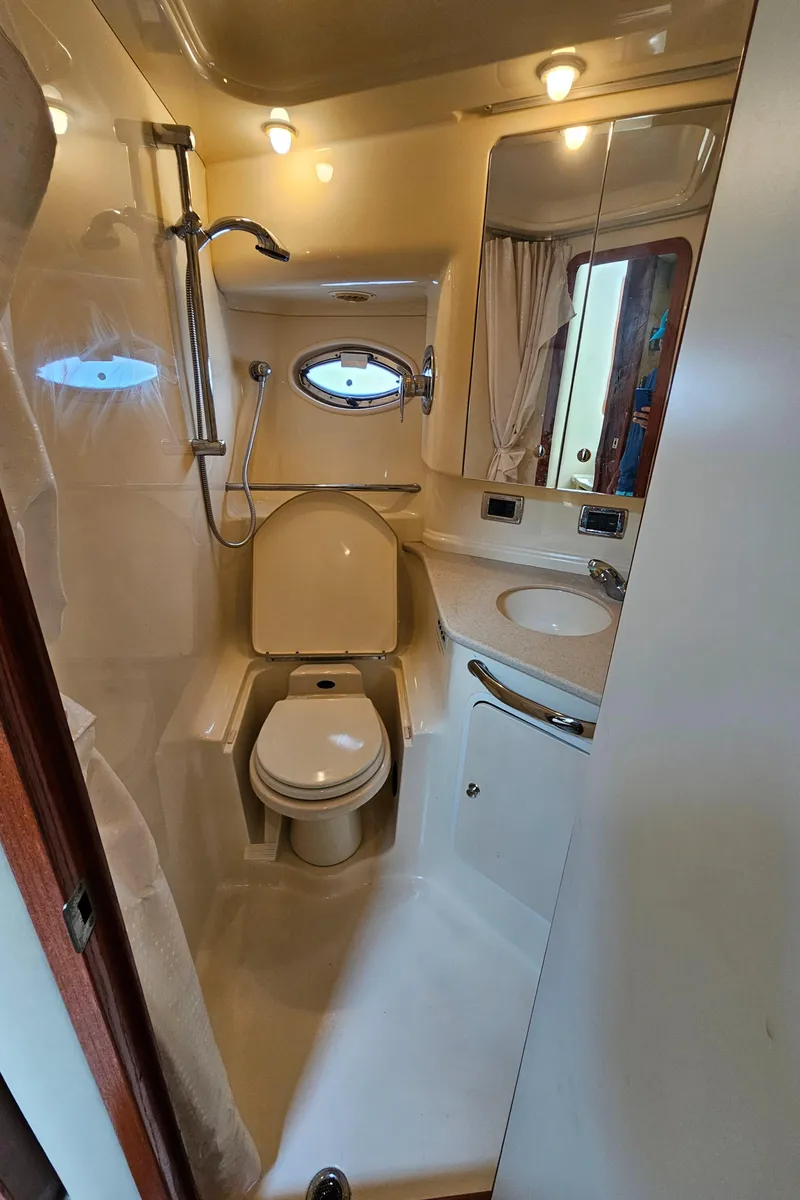 Slide: The Image of 2002 Sea Ray 460 Sundancer bathroom with shower, toilet, and sink. - 29