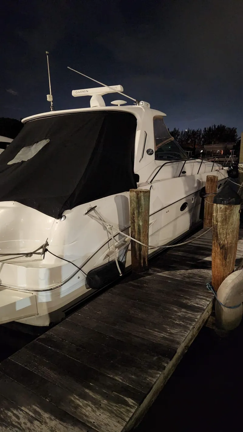 Slide: The Image of 2002 Sea Ray 460 Sundancer yacht docked at night. - 31