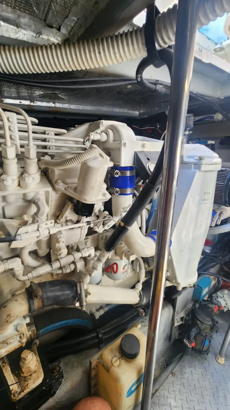 Slide: The Image of Engine room of 2002 Sea Ray 460 Sundancer, showcasing mechanical components and piping. - 32