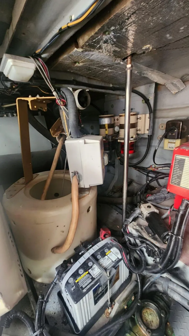Slide: The Image of Engine room of 2002 Sea Ray 460 Sundancer with various mechanical components. - 34