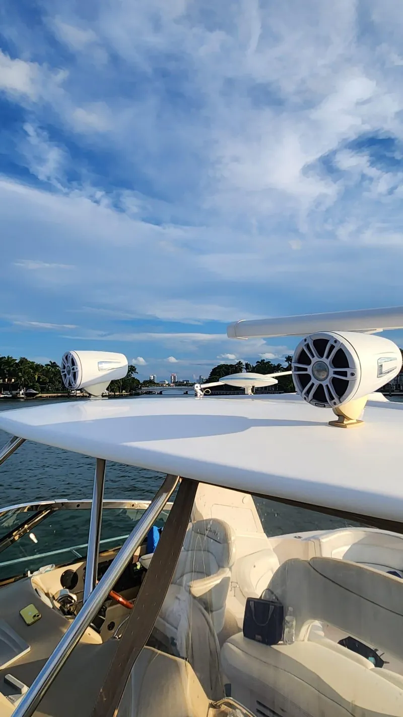 Slide: The Image of 2002 Sea Ray 460 Sundancer yacht with speakers, under a vibrant blue sky. - 5