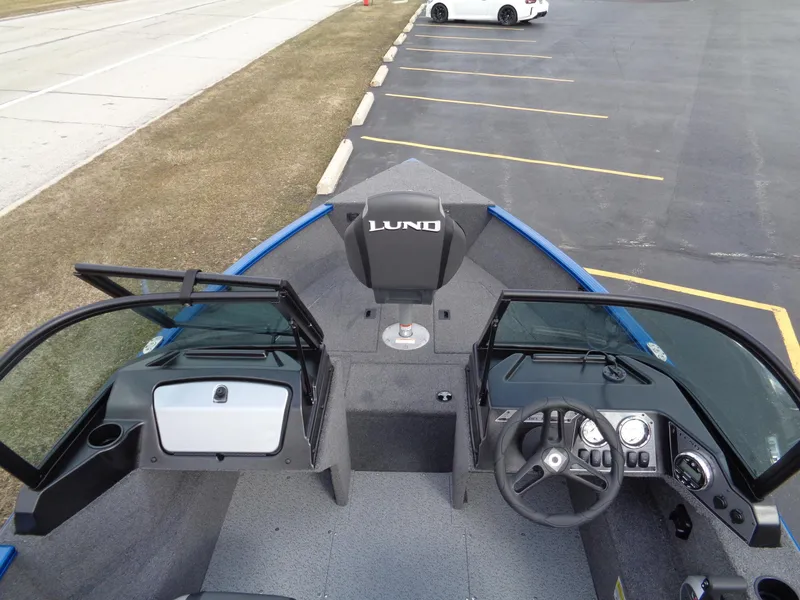 Slide: The Image of 2024 Lund 1650 Rebel XL Sport boat interior with steering wheel and seating. - 15