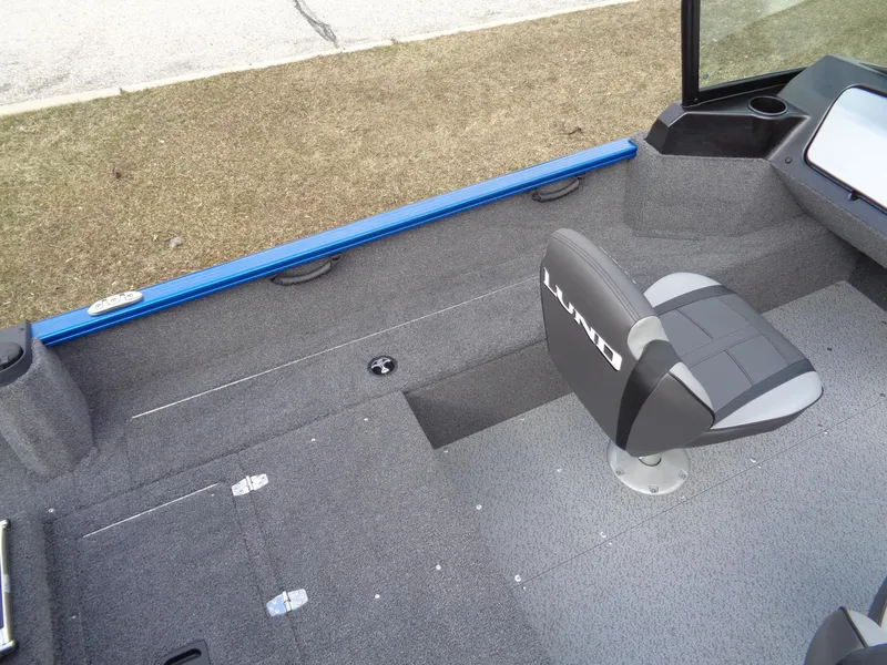 Slide: The Image of 2024 Lund 1650 Rebel XL Sport interior with gray seating and carpeted flooring. - 18