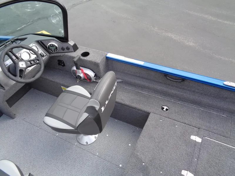 Slide: The Image of 2024 Lund 1650 Rebel XL Sport boat interior with steering wheel and seating. - 9