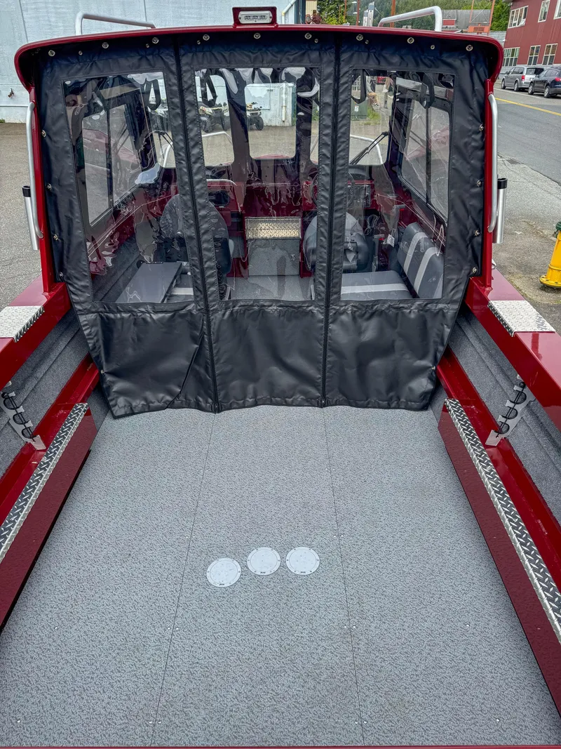 Slide: The Image of 2024 Hewescraft 200 ProV ET HT boat interior with protective cover, red exterior. - 7
