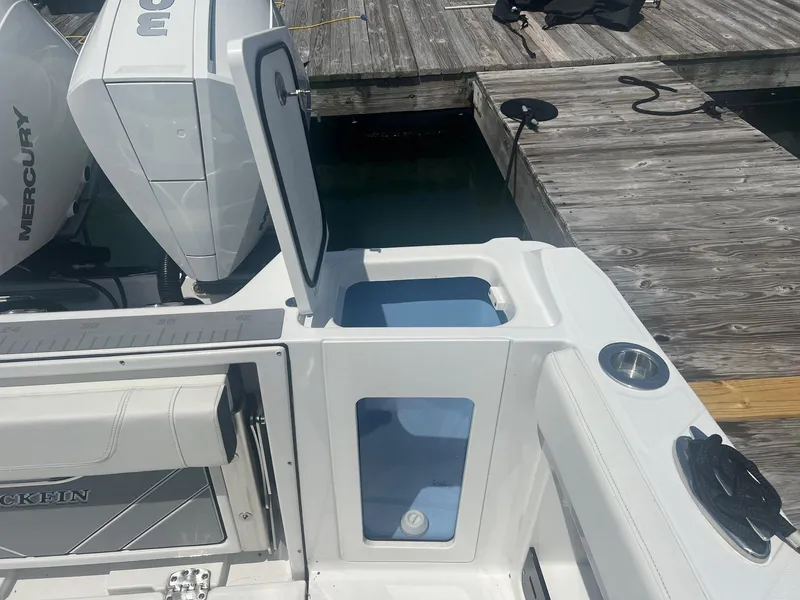 Slide: The Image of Close-up of 2023 Blackfin 302 CC boat's digital dashboard displaying engine hours and maintenance life. - 14